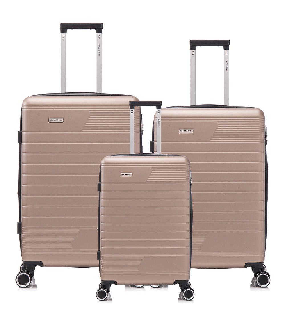 Set de 3 valises rigides champagne avec roulettes pivotantes, idéal pour voyager avec style.